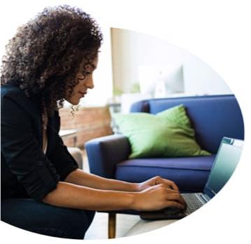 Woman leaning over laptop computer